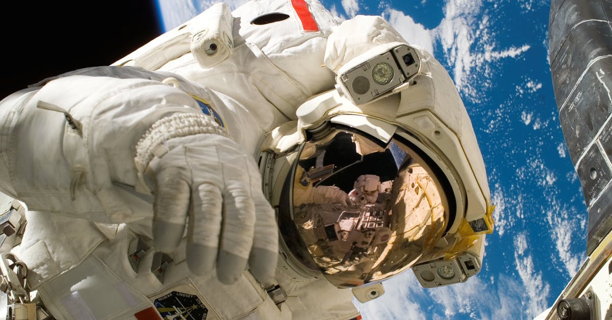 How do the travelers/couriers know what universe to take the films to? - This picture shows an american astronaut in his space and extravehicular activity suite working outside of a spacecraft. In the background parts of a space shuttle are visible. In the far background of the picture planet earth with it's blue color and whi