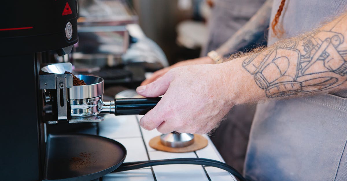 How do they make tattoos in movies? - Tattooed man preparing coffee with coffee machine