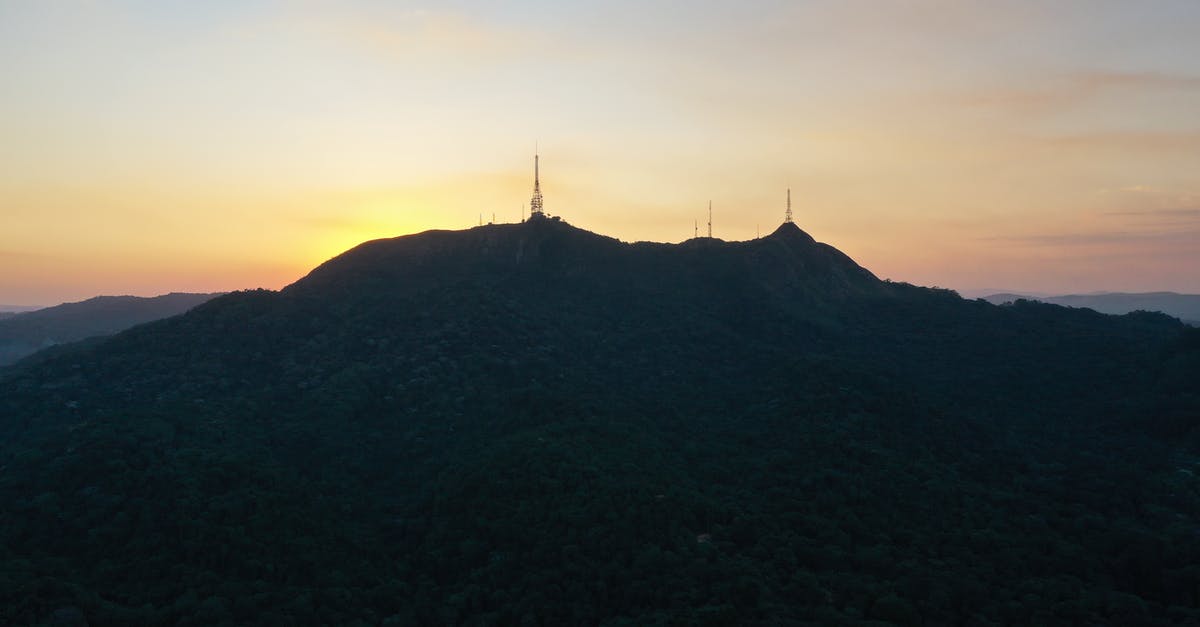 How do you identify a song in a TV score? - Picturesque scenery of silhouette of Pico do Jaragua mountain with TV towers located in Sao Paulo against sunset sky
