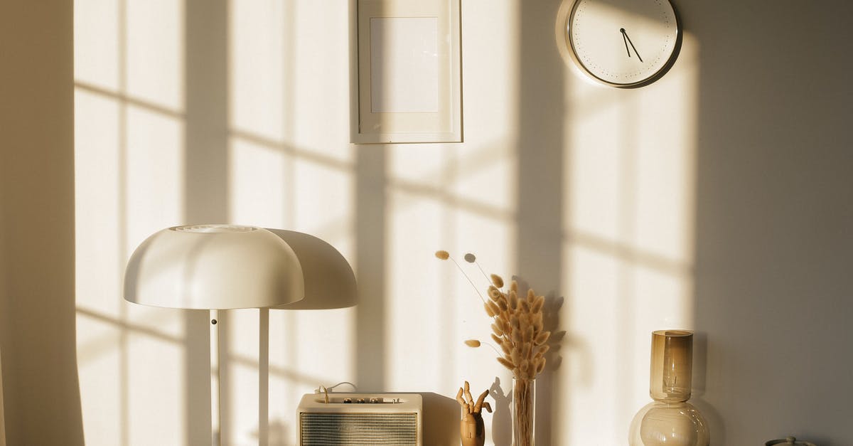 How does a Vow of Silence relate to Nietzsche? - Light room with retro radio and decorative vases with dry plants on desk near wall with clock and window shadow in sunlight