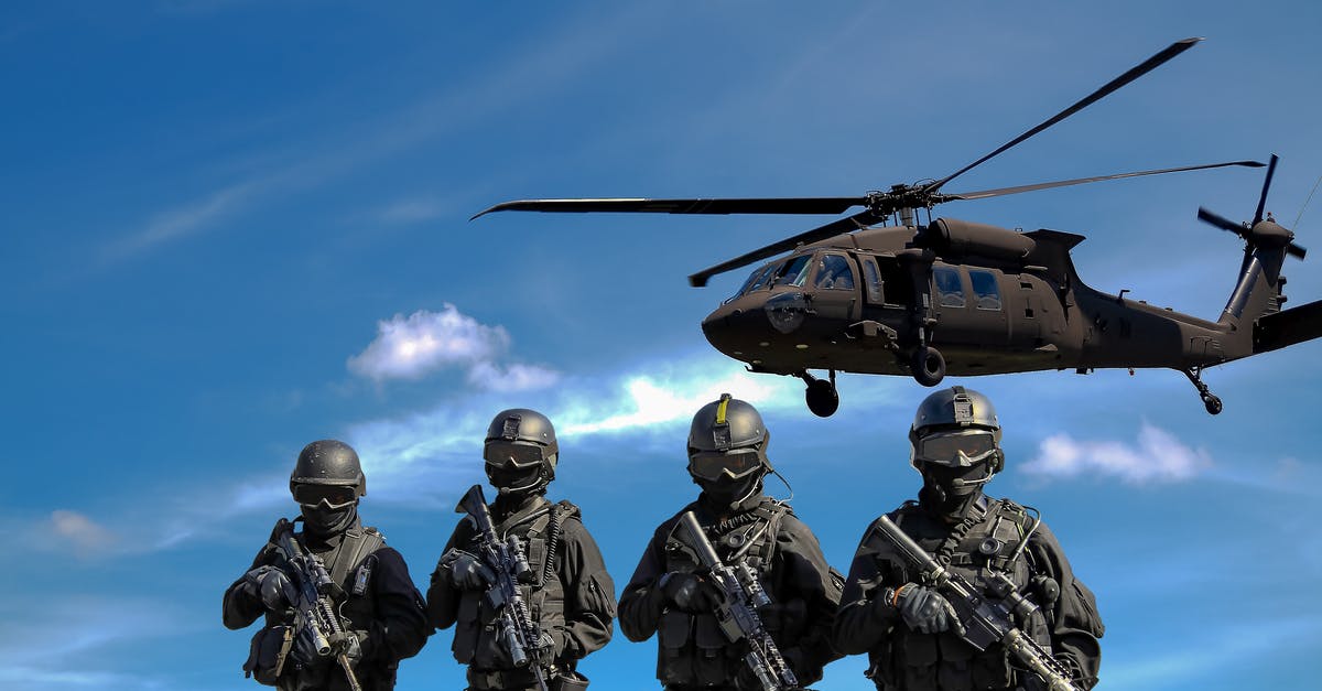 How does Agent Vinod link Zeus Group to the terrorist attack? - Four Soldiers Carrying Rifles Near Helicopter Under Blue Sky