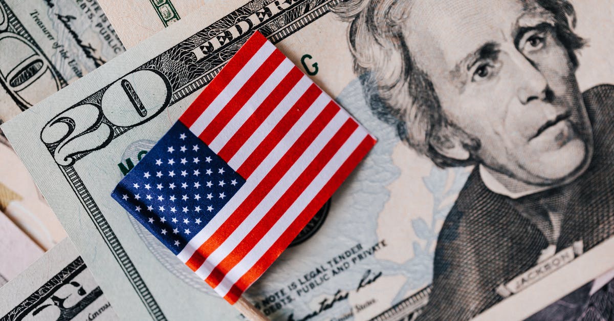 How does an average (non-star) actor's pay work? - From above of small American flag placed on stack of 20 dollar bills as national currency for business financial operations