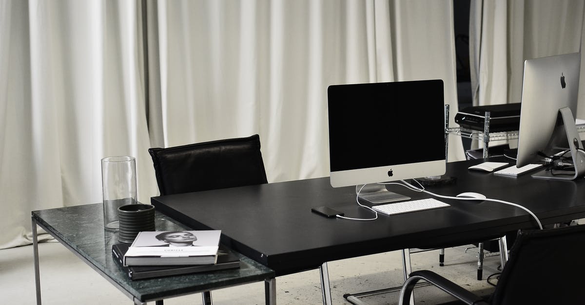 How does Derek Vinyard get away with only a Manslaughter charge for the "Curb-Stomp"? - Black and white of workspace of office with computers placed on table with wireless mouse and keyboard near smartphone
