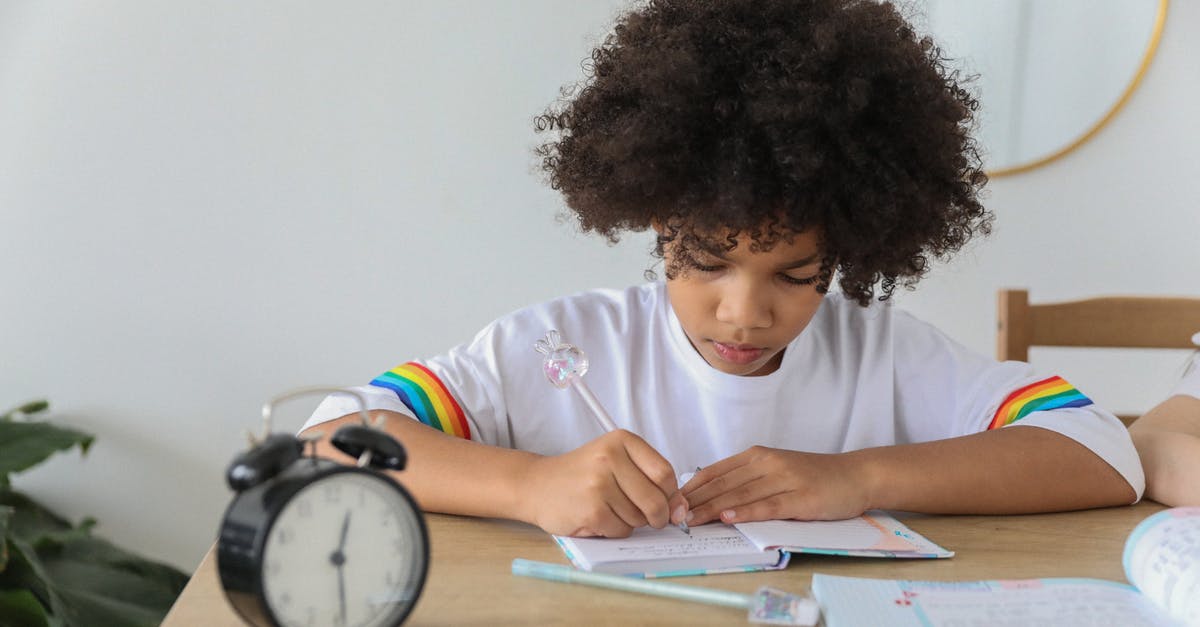 How does Indiana Jones take so much time off to treasure hunt? - Concentrated African American child writing in notebook while studying at desk with alarm clock at home