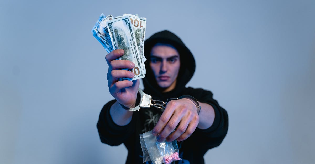 How does Joey have money to lend? - A Man in Black Hoodie Sweater Wearing Handcuffs while Holding Money and Drugs