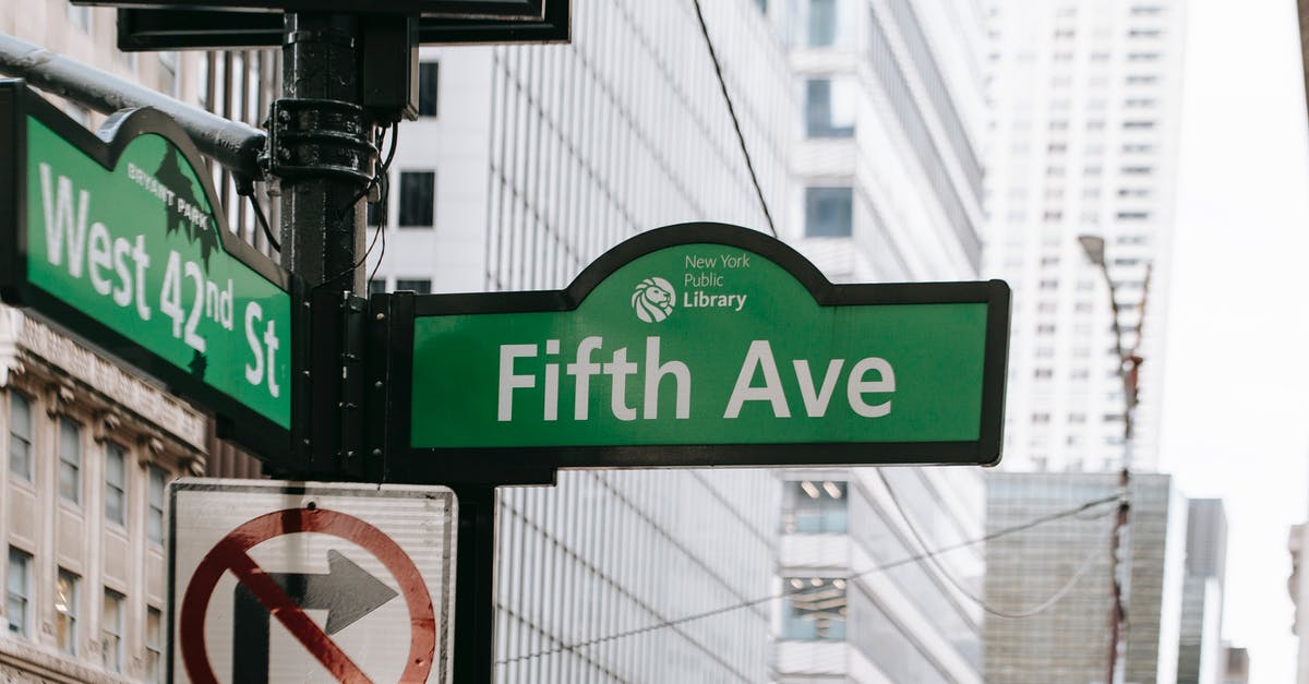 How does Mark know Franco was after him? - Metal post with direction indicator on avenue with high skyscrapers in New York