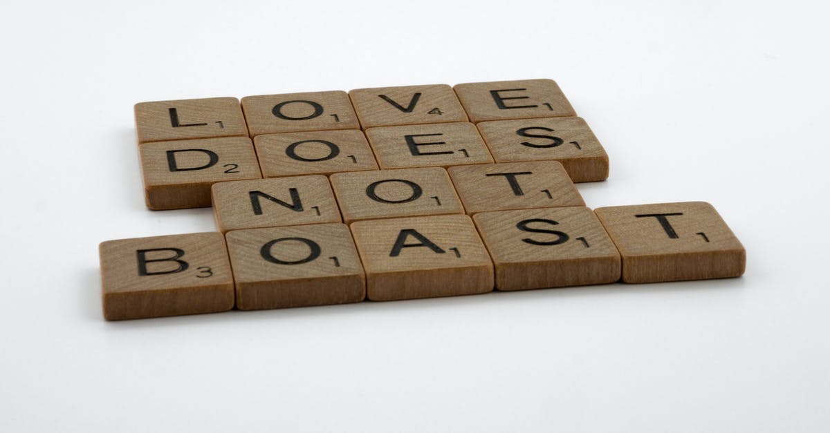 How does Murphy overcome the "Red Asset"? - Close-Up Shot of Scrabble Tiles on a White Surface