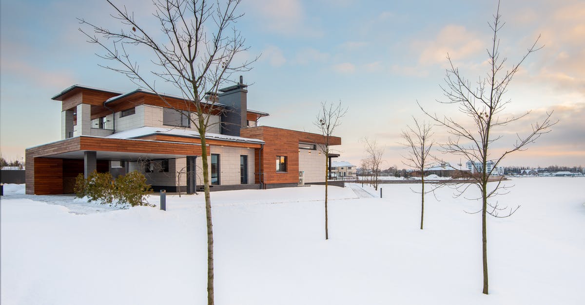 How does Smiley know the location where Jim Prideaux is? - Exterior design of new residential two storey house with modern stone and wooden facade and spacious yard located in suburban area in wintertime