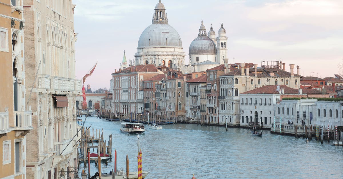 How does Steve escape from the building in Venice - View of grand canal and old cathedral of Santa Maria della Salute in Venice in Italy on early calm morning