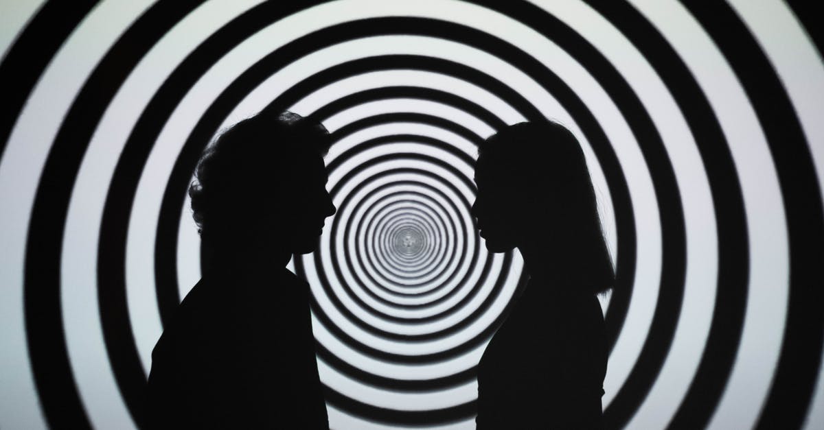 How Does the Isabella Hallucination Work? - Silhouette of 2 Person Standing in Front of White and Black Stripe Wall