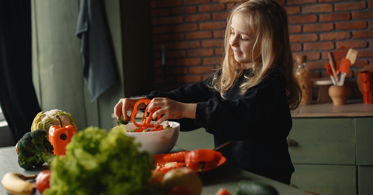 How does the Macbeths' child add to their characterization and does it have a precedent? - Adorable smiling child adding sliced pepper in salad bowl standing near table with assorted vegetables and fruits during vegetarian meal preparation