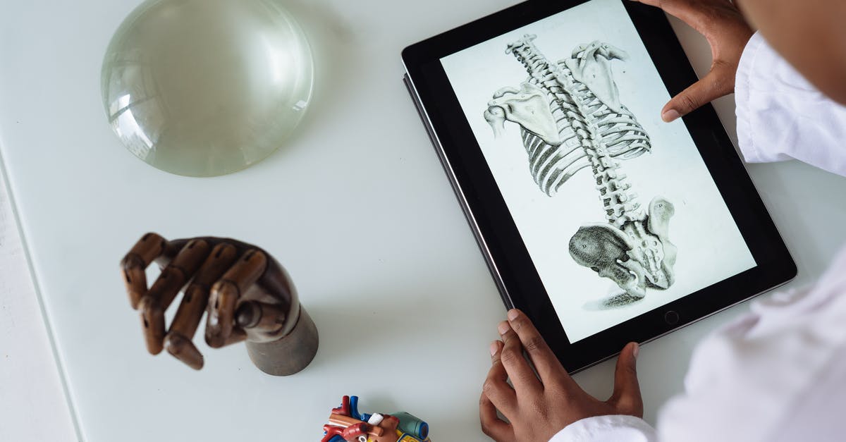How does the mad scientist obtain a digital copy of the classified document? - Unrecognizable African American scientist studying anatomy with tablet