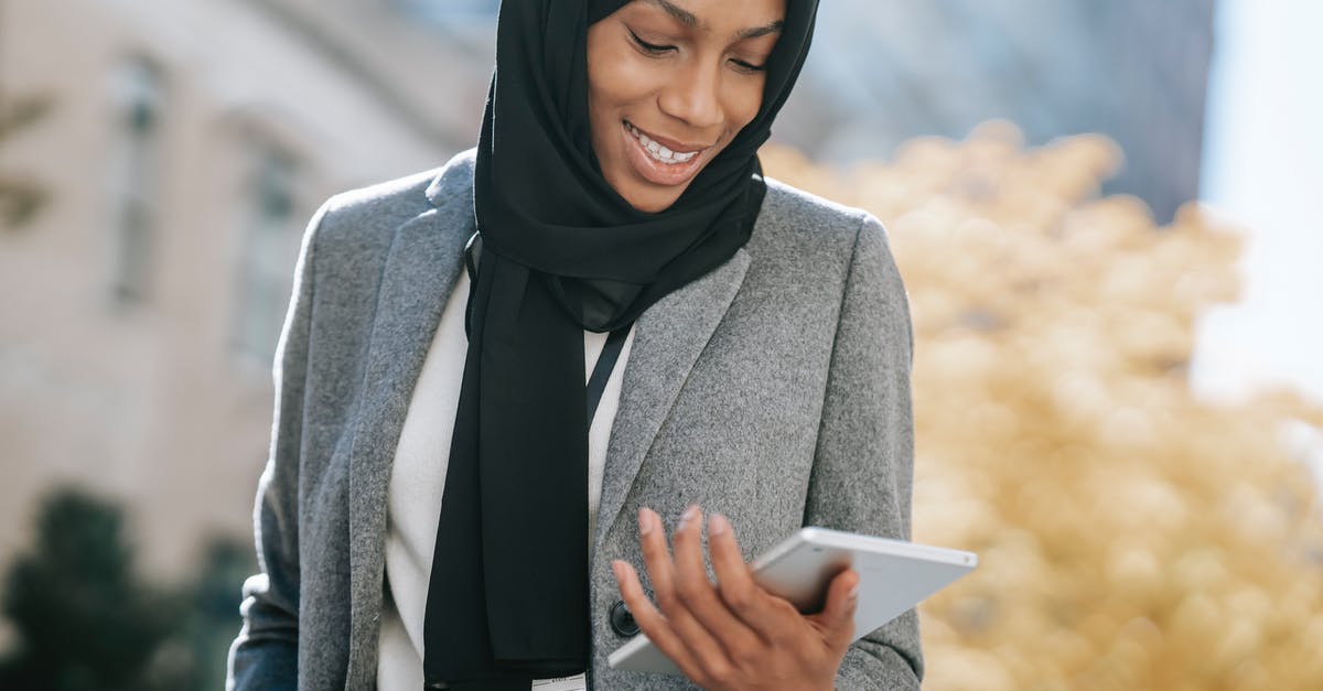 How does the veteran identify this woman as Spanish? - Black woman in hijab browsing tablet