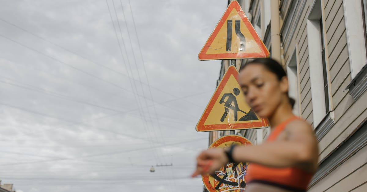 How does Tokyo Drift fit into the time line? - A Woman in Orange Sports Bra Standing Near the Road Signs