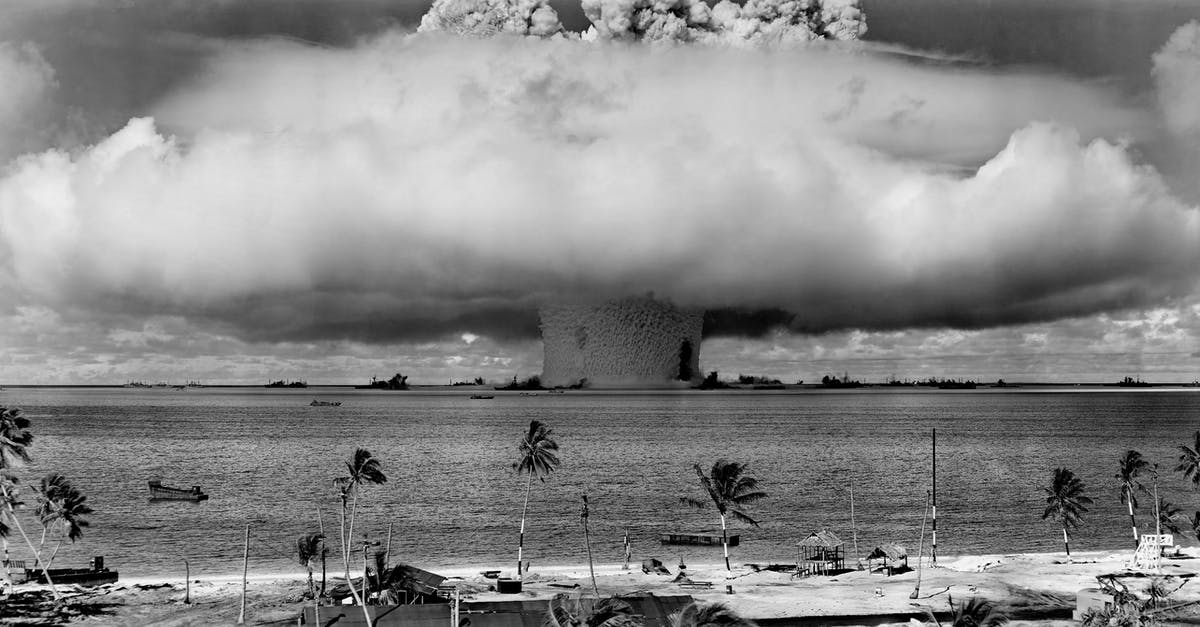 How does Venom survive the blast from the rocket? - Grayscale Photo of Explosion on the Beach