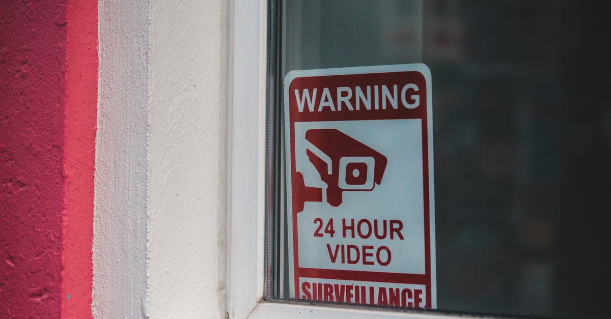 How does video come on the walls of the buildings? - Signboard video surveillance placed on window in daytime