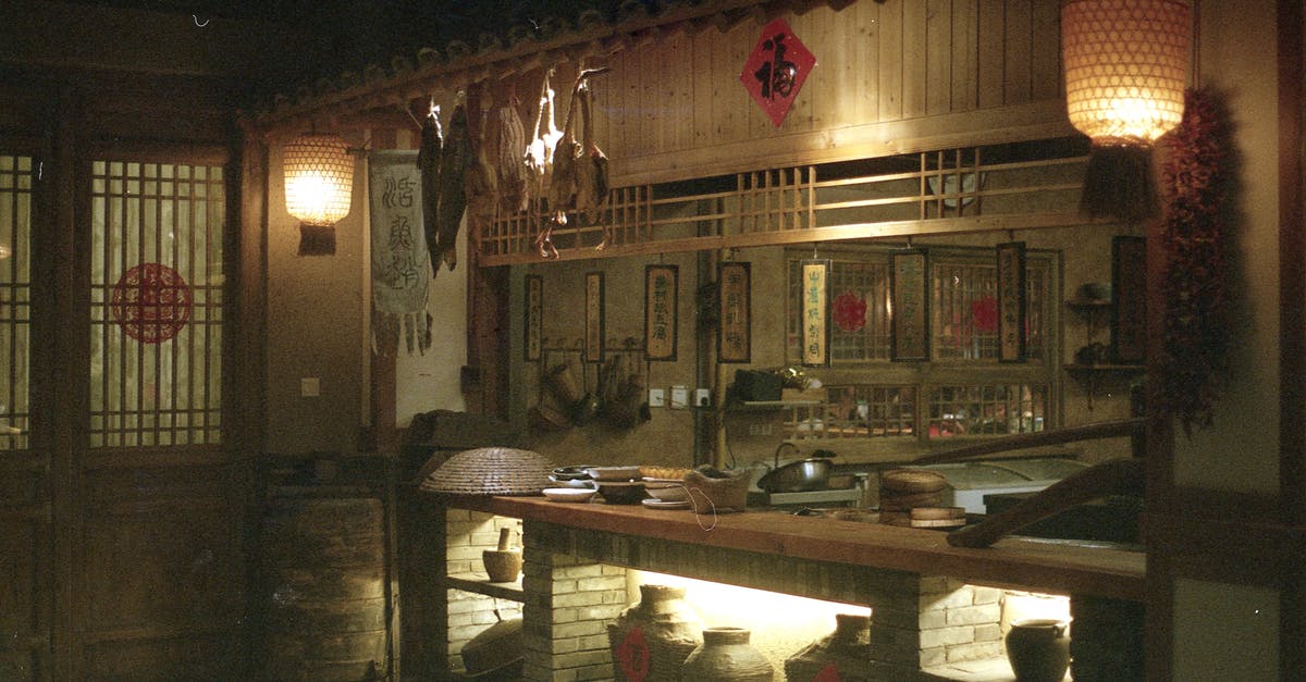 How has "Unbroken" fared in Asian markets? - Interior of oriental restaurant with wooden door near counter and dim illumination from lamps