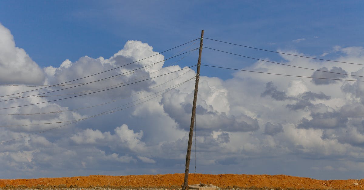 How is electricity generated in A Quiet Place? - Lonely pillar with wires under cloudy sky