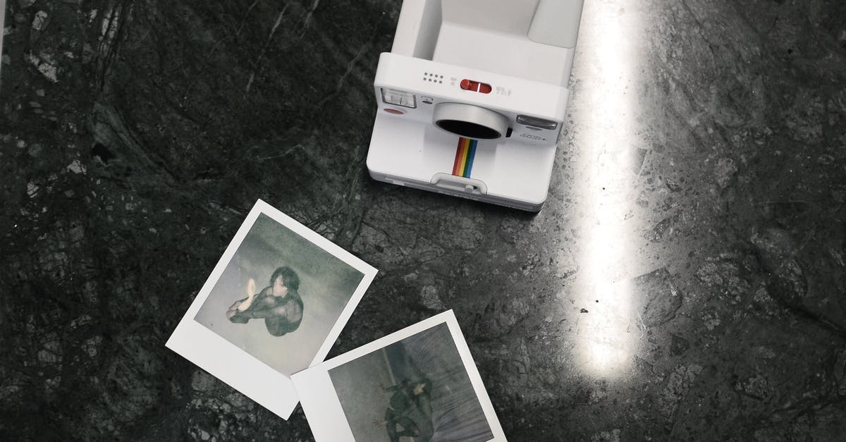 How is Gideon able to capture people of Gravity Falls in appropriate camera angles? - Modern instant photo camera and photos placed on marble surface