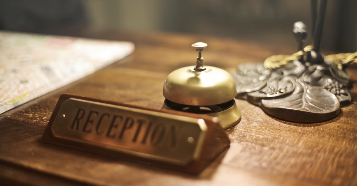 How is Max going to get out of it at the end of Welcome to the Punch? - Old fashioned golden service bell and reception sign placed on wooden counter of hotel with retro interior