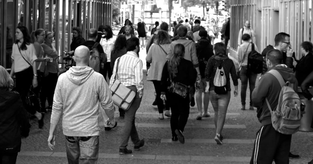 How is Themiscyra populated? - Grayscale Photography of People Walking Near Buildings