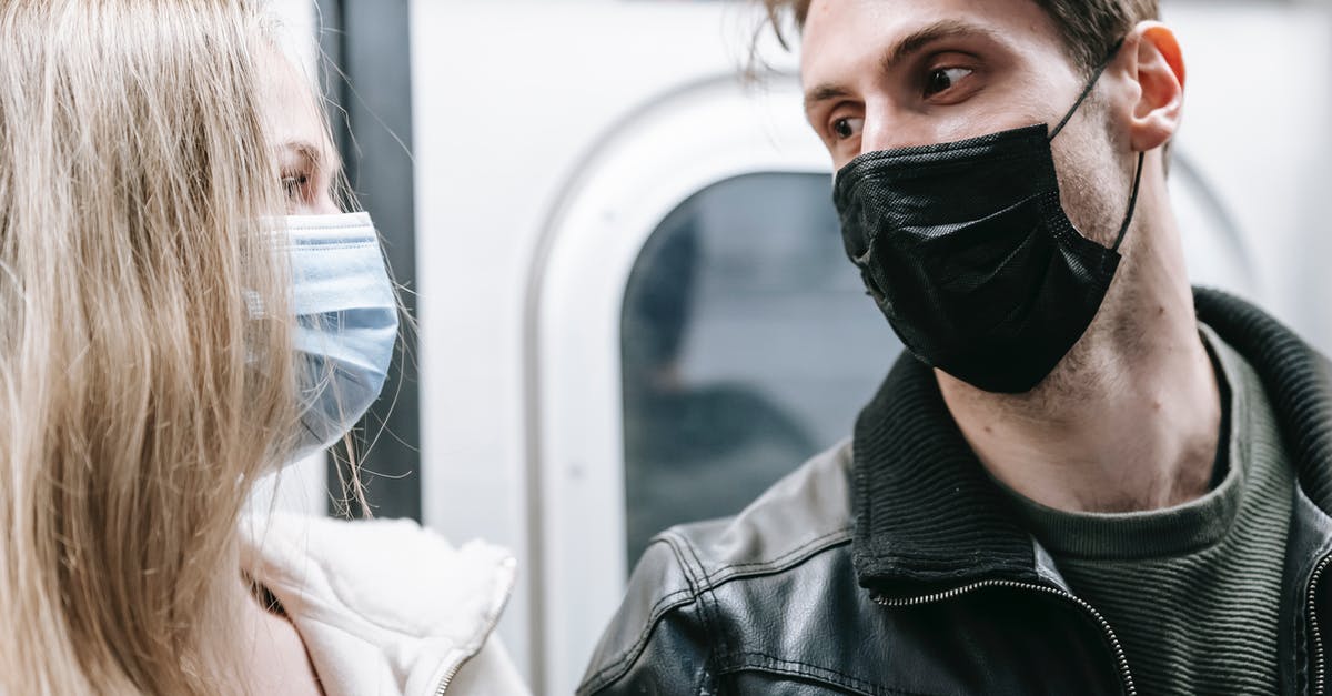 How is this movie so close to current epidemic due to COVID-19? [closed] - Couple in medical masks standing in subway