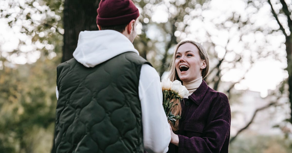 How long did Rose and Jack know each other for? - Loving boyfriend in hat giving bunch of roses as gift to happy girlfriend with long hair in casual warm clothes in park