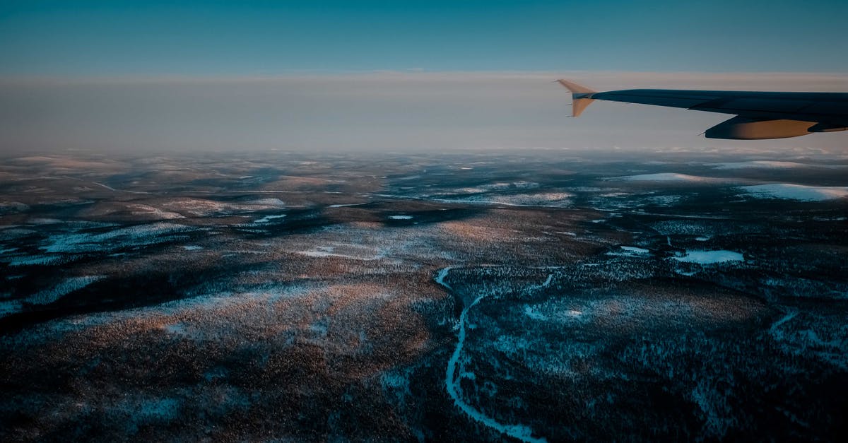 How Long Was the Trip from Earth to the Axiom? - View from airplane of wild snowy valley with curvy frozen rivers located in vast deserted terrain in winter evening