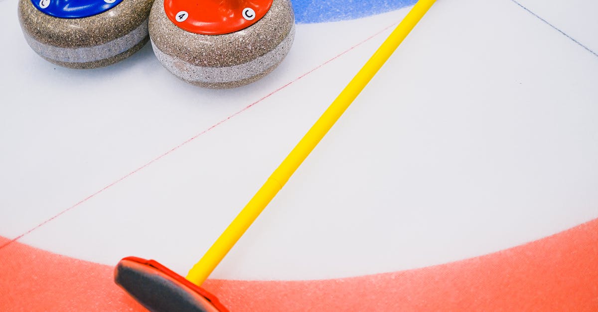 How many game systems does Steven own? - From above of granite curling stone and broom placed on ice sheet in house with colorful target area in playing area