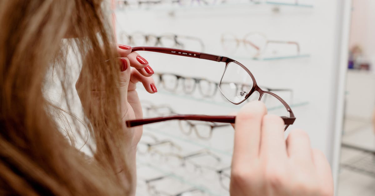 How many options actually exist? - Woman selecting eyewear in store with various rims