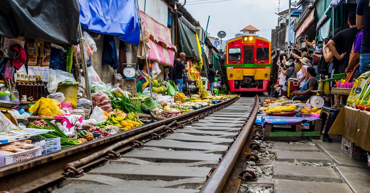 How many people are there onboard the train in Snowpiercer (2013)? - Mae Klong train market in Samut Songkhram, Thailand