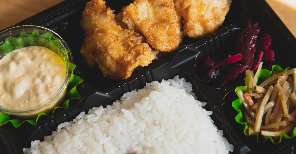 How much he is going to serve in prison for his crime? - From above of plastic container with fried chicken and rice with sauce near sauce and sliced vegetables