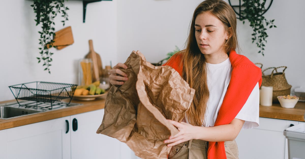 How much is Claire Underwood aware of her husband's more serious deeds? - Young serious female with long hair sorting reusable paper trash in modern kitchen in apartment
