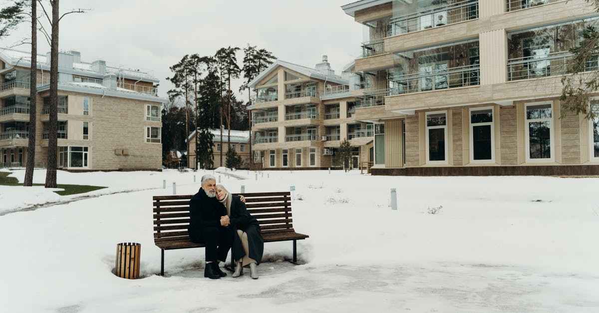 How old are Love Händel? - Photo of an Elderly Couple Sitting on a Wooden Bench