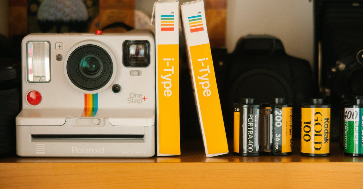 How to find films that contain a specific motif? [closed] - White Polaroid Land Camera Beside Photo Paper Boxes and Photo Films