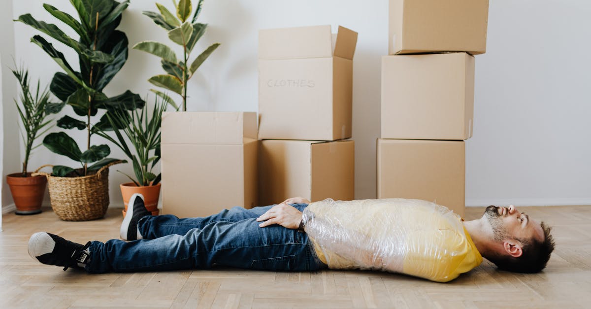 How to find films that contain a specific motif? [closed] - Full body side view unemotional male wearing casual outfit lying on floor with upper body tied up with tape and tired after packing belongings into carton boxes
