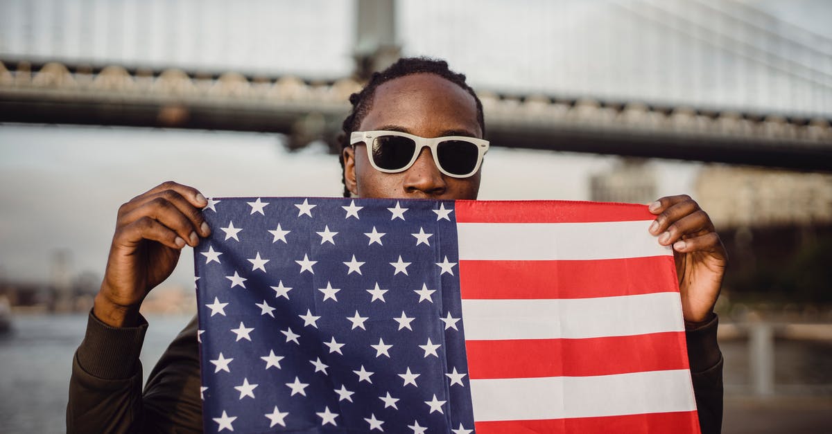 How was Coming to America received in the black community? - Young African American male with American Flag bandana against bridge
