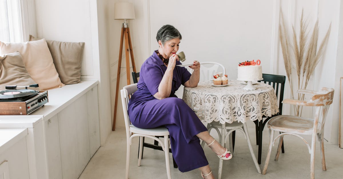 How was the cake poisoned at the Purple Wedding? - Woman in Purple Jumpsuit Holding Cup