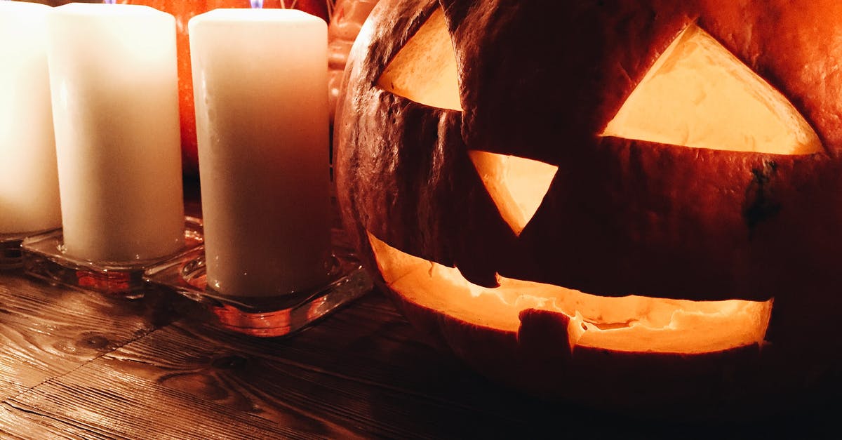 How was the fire stunt done in Cape Fear (1991)? - Spooky carved Jack o lantern pumpkin placed on wooden table near burning candles during Halloween party