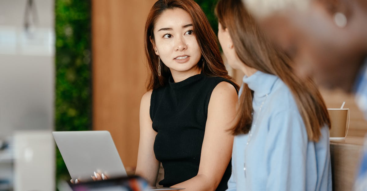 How were both Plan A and Plan B supposed to work together? - Asian woman discussing business plan with diverse colleagues