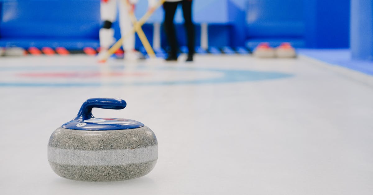 How were the others able to handle the power of the stone? - Curling stone placed on ice against sportsmen on ice rink