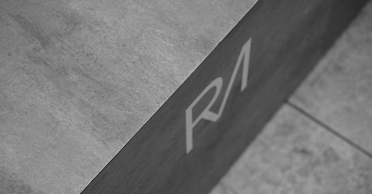 Identify this studio's logo or trademark [closed] - Grayscale Photo of Initials On Concrete Surface