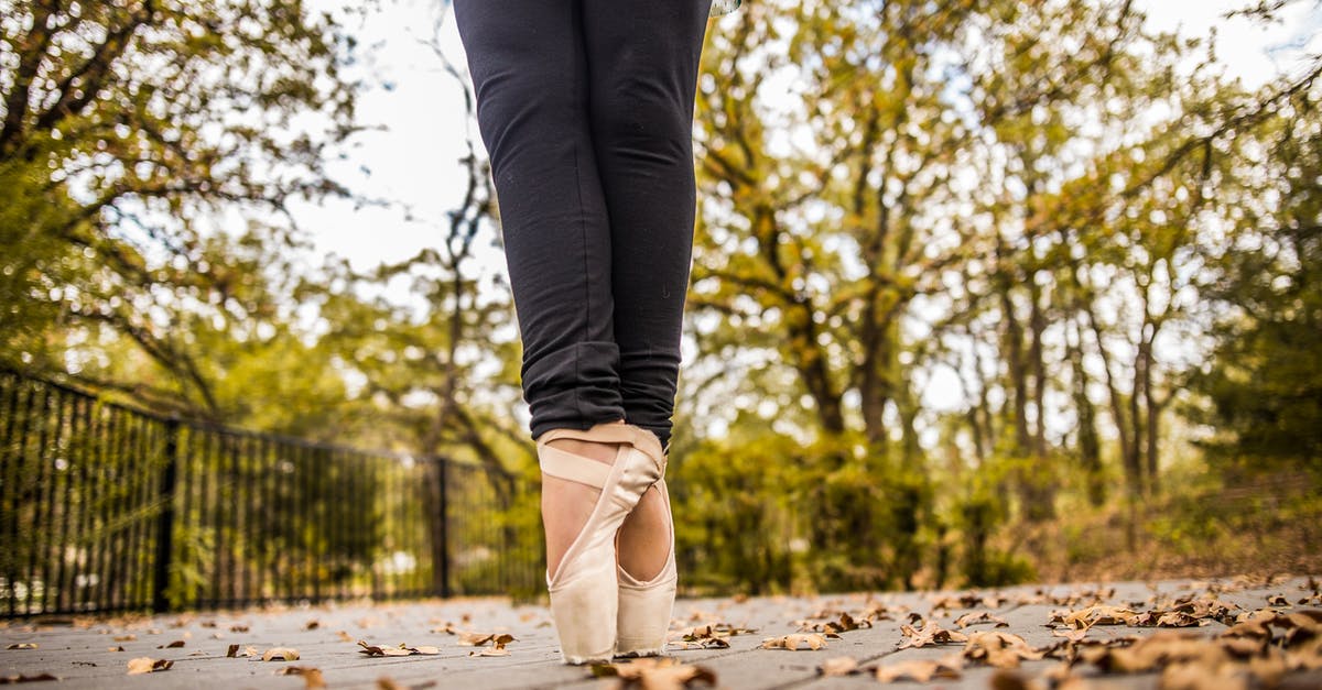 If Cinderella's shoe fit perfectly, why did it fall off? - Crop ballerina standing on toes in autumn park