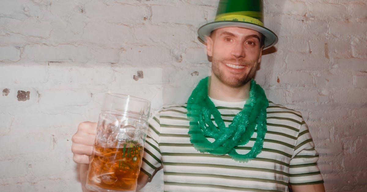 If events happen that Michael doesn’t know about, does that mean that he isn’t dreaming? - Through glass wall view of smiling male in shamrock hat looking at camera with jar of beer during Feast of Saint Patrick