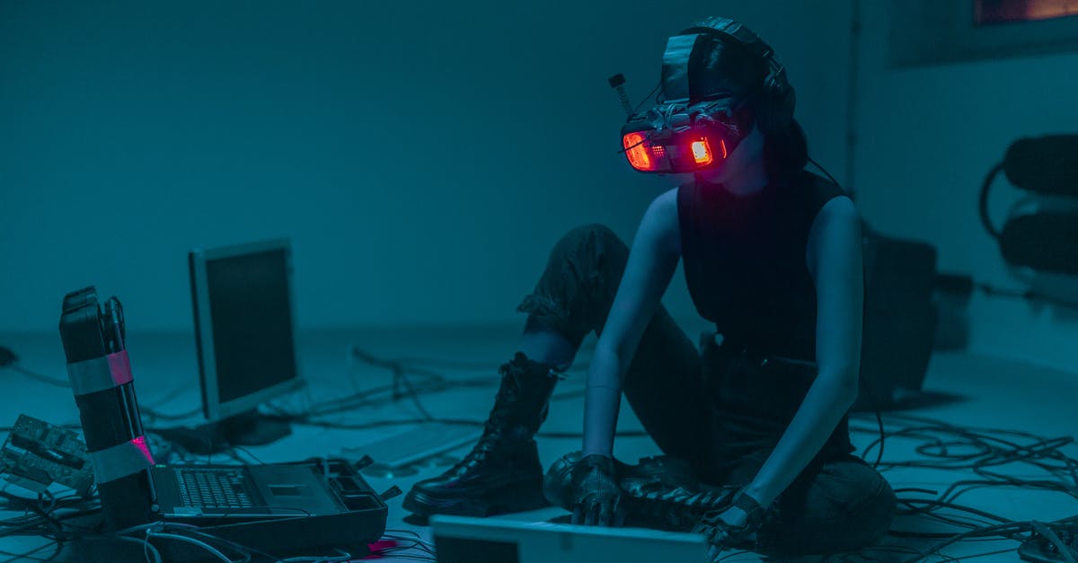 If Liber8 can hack Keira, why doesn't Keira or Alec hack them back? - A Person Sitting on the Floor with Vr Goggles Using a Computer