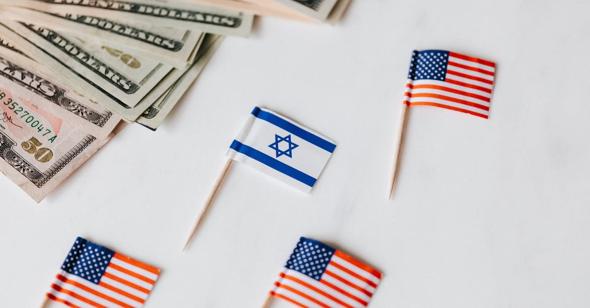 In Avatar, does Ninat refer to Ninet Tayeb, Israeli singer? - From above closeup of Israeli and American flags on toothpicks and different nominal pars of dollar banknotes on white background