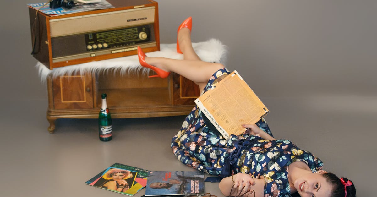 In Bollywood, do they play the song while shooting? - Happy woman lying on floor near vintage disks and record player