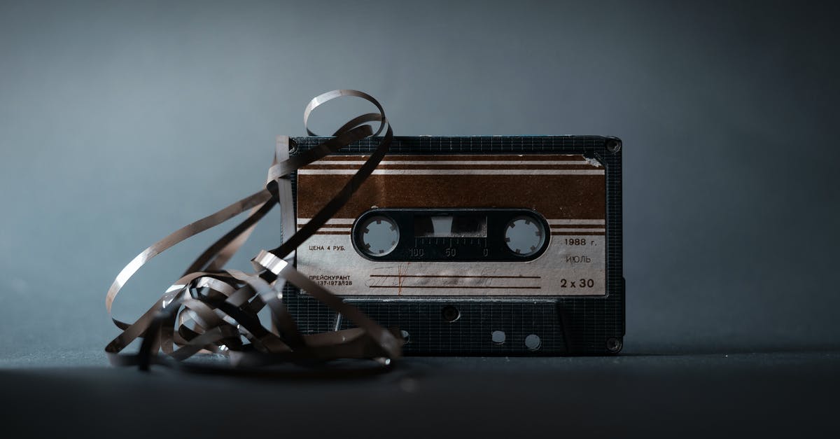 In Mystic River, How did listening to the 911 tape solve the case? - Retro audio cassette with tape out placed on gray surface and illuminated by light in studio