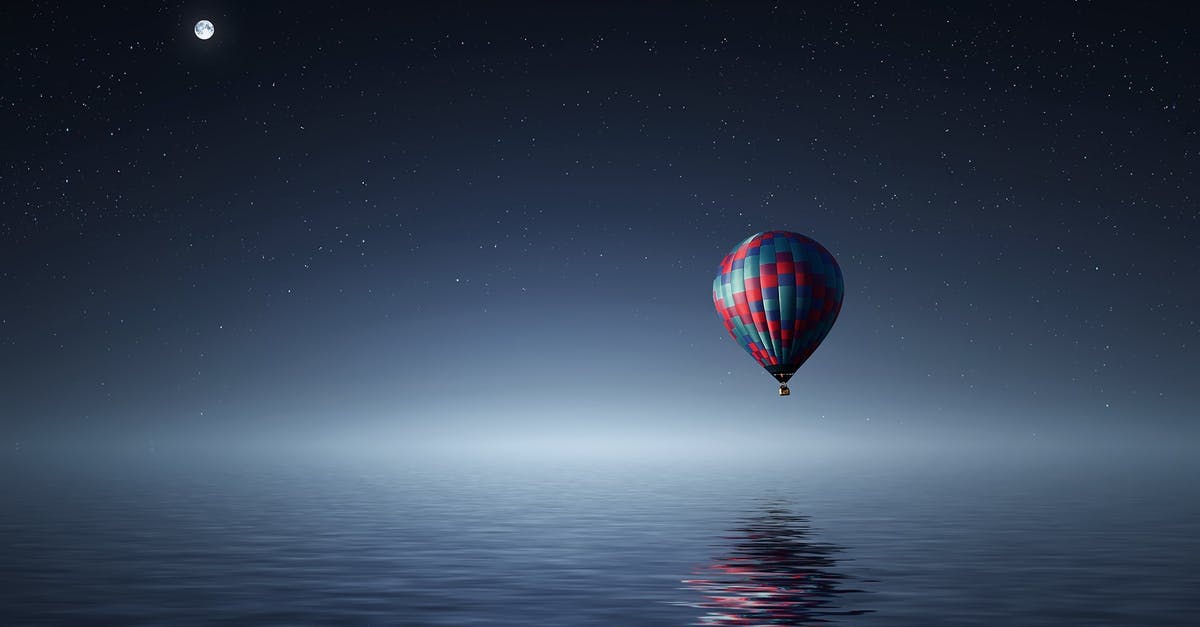 In Ocean's Twelve, how did the Night Fox make the switch? - Red and Blue Hot Air Balloon Floating on Air on Body of Water during Night Time