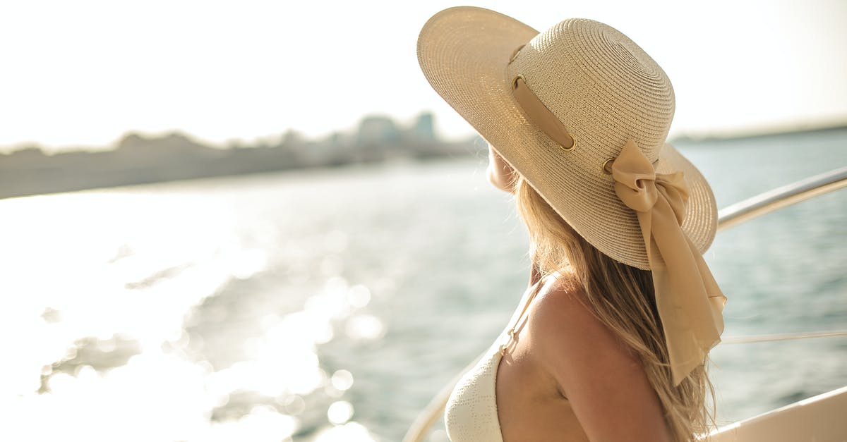 In Serenity, how did the woman on Miranda survive? - Back view of slim female in bikini top and straw hat enjoying trip on cruise boat on sunny day while relaxing during summer vacation and looking away